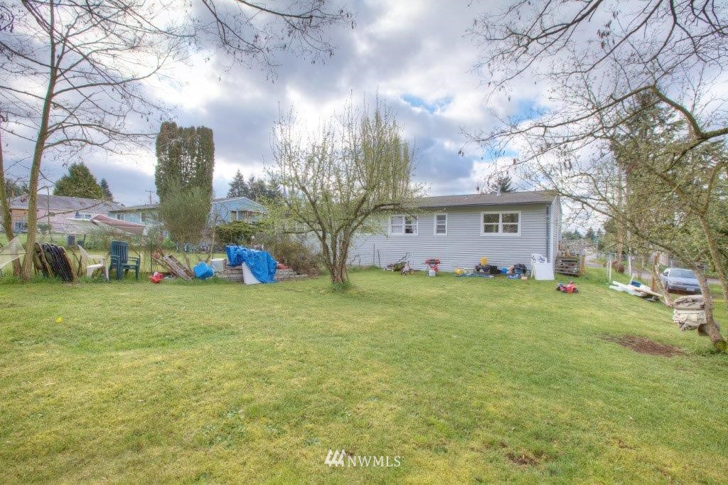 2818 Northeast 6th Place Renton, WA 98056 - Photo 2 of 11 a front view of a house with garden
