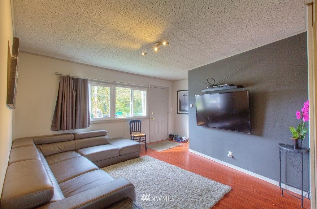 2818 Northeast 6th Place Renton, WA 98056 - Photo 3 of 11 a living room with furniture and a flat screen tv