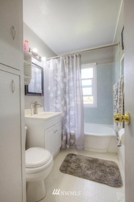 2818 Northeast 6th Place Renton, WA 98056 - Photo 6 of 11 a bathroom with a sink a toilet and shower