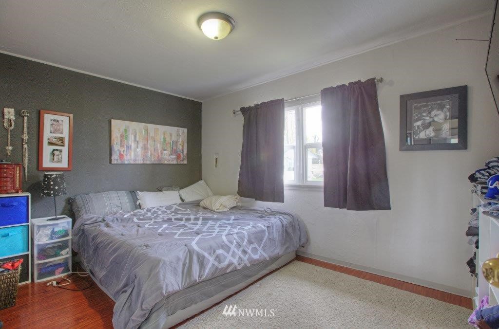 2818 Northeast 6th Place Renton, WA 98056 - Photo 7 of 11 a bedroom with a bed and window