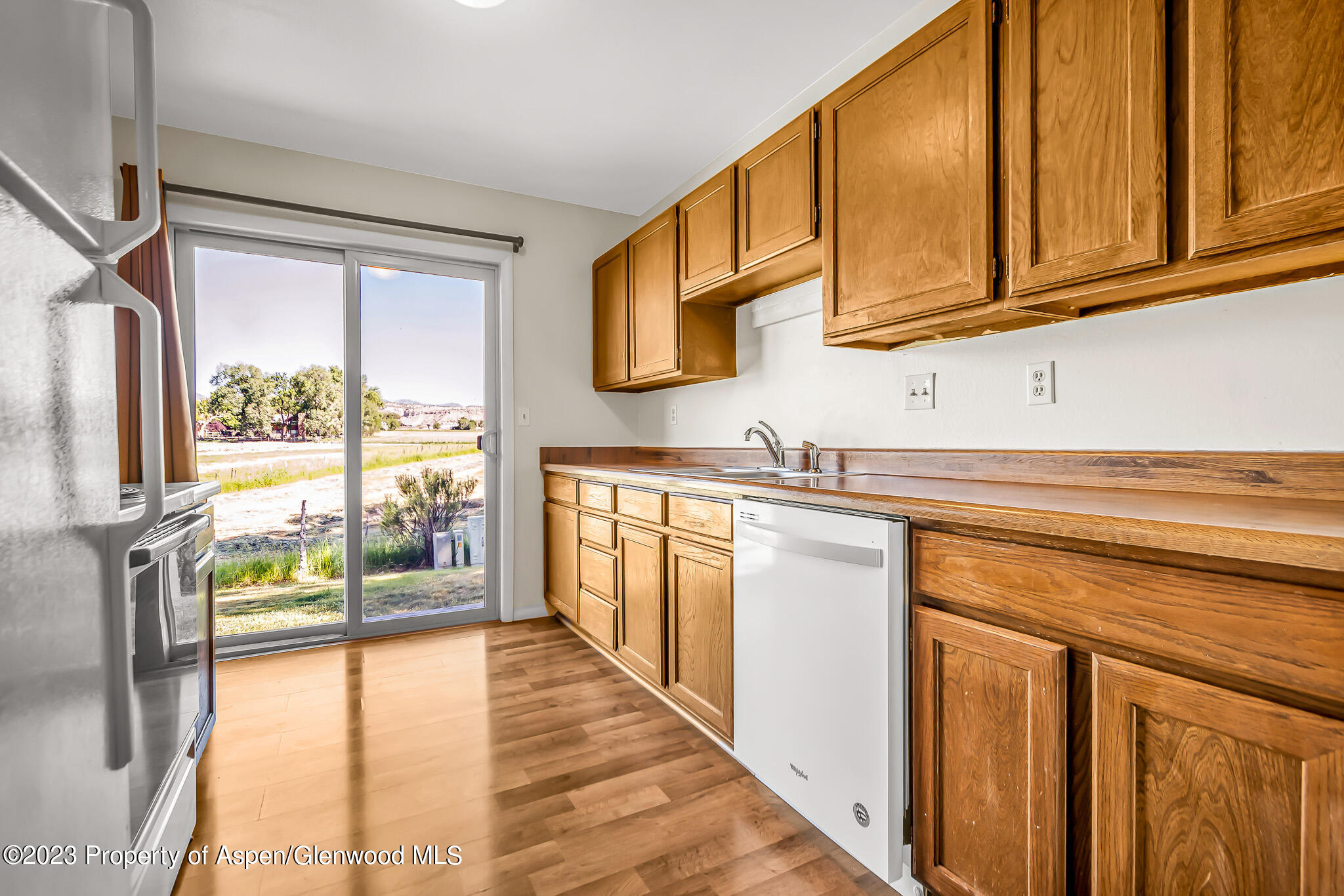 1006 Wamsley Way Rifle, CO 81650 - Photo 6 of 16 a kitchen with stainless steel appliances granite countertop a stove a sink and a refrigerator