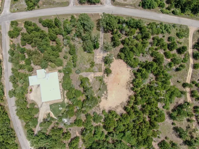 an aerial view of a house with a yard