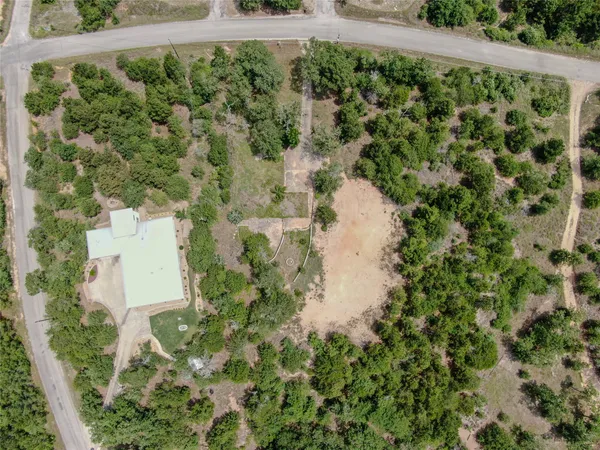 an aerial view of a house with a yard