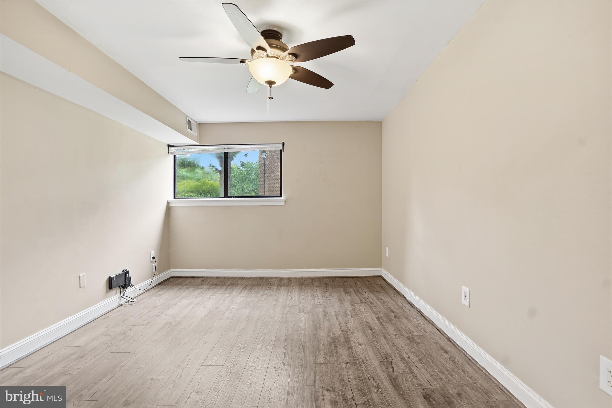 8487 Greenbelt Road Greenbelt, MD 20770 - Photo 20 of 29 an empty room with wooden floor and windows