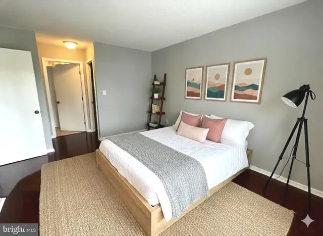 a bedroom with a bed and a painting on the wall