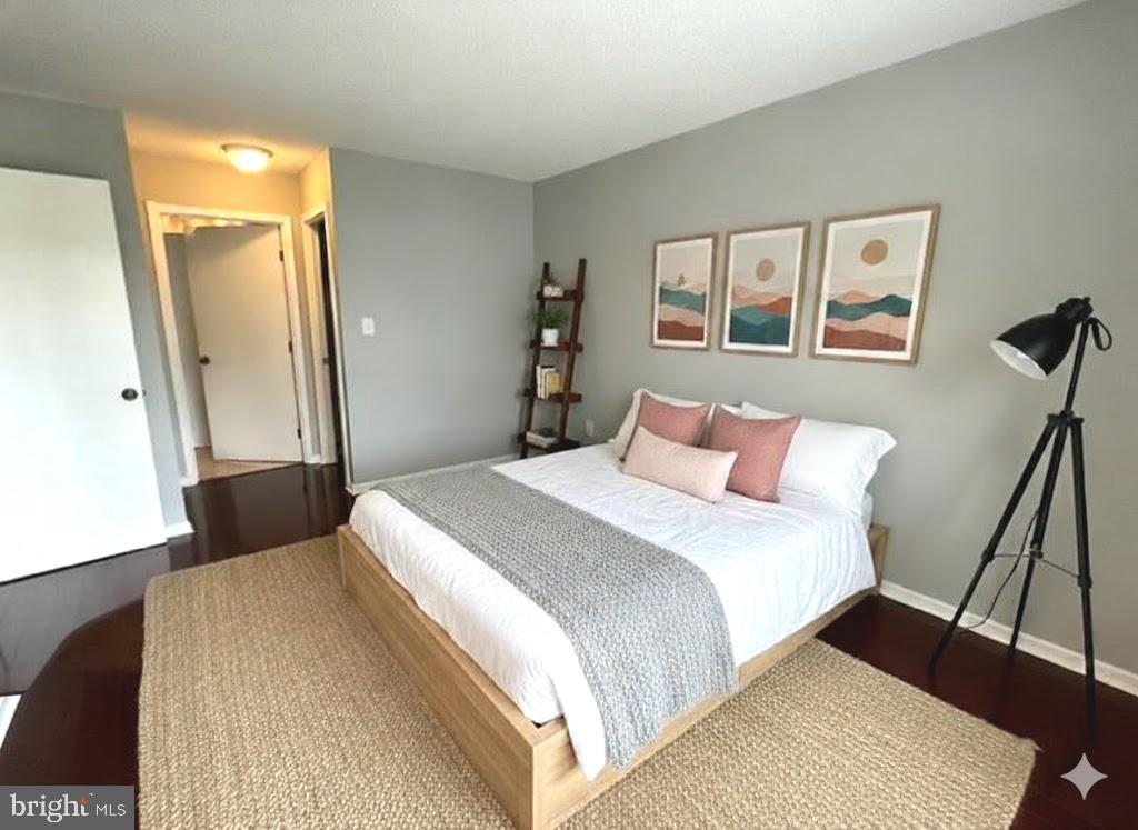 2111 Wisconsin Avenue Northwest, Unit 420 Washington, DC 20007 - Photo 11 of 28 a bedroom with a bed and a painting on the wall