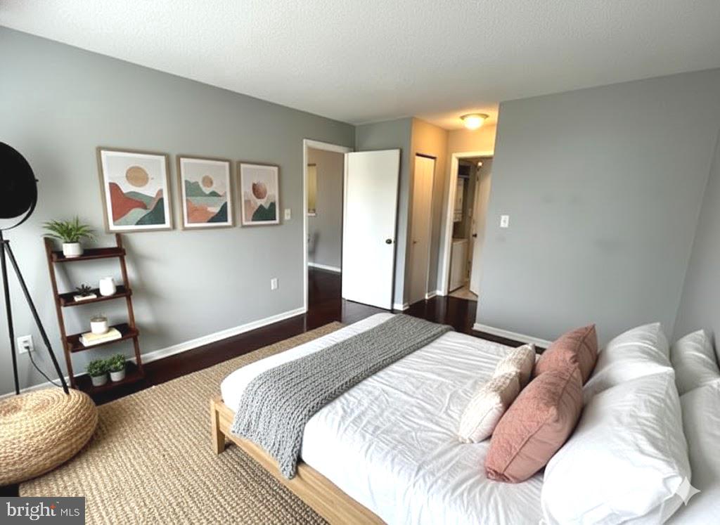 2111 Wisconsin Avenue Northwest, Unit 420 Washington, DC 20007 - Photo 13 of 28 a bedroom with a bed and a mirror