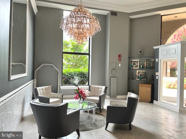 2111 Wisconsin Avenue Northwest, Unit 420 Washington, DC 20007 - Photo 20 of 28 a living room with furniture and a chandelier