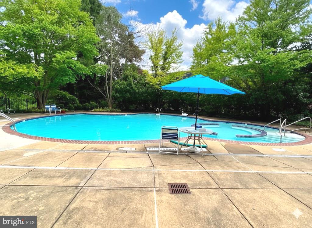 2111 Wisconsin Avenue Northwest, Unit 420 Washington, DC 20007 - Photo 22 of 28 a patio with a table and chairs under an umbrella