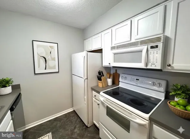 a kitchen with stainless steel appliances a refrigerator and a stove top oven