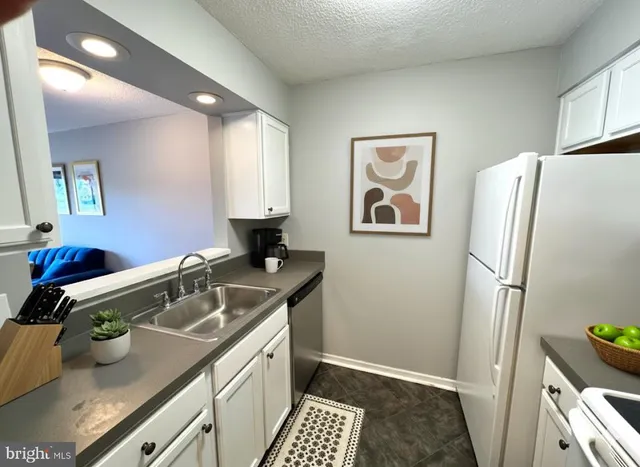 a bathroom with a sink and a refrigerator