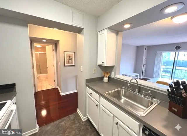 a kitchen with a sink and a refrigerator