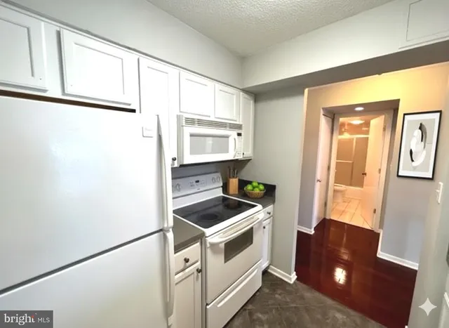 a room with window and white cabinets