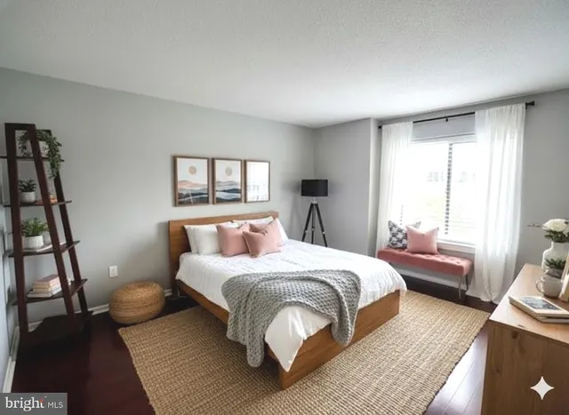 a bedroom with a bed a couch and a window