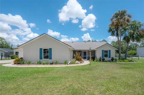 a front view of house with yard and green space