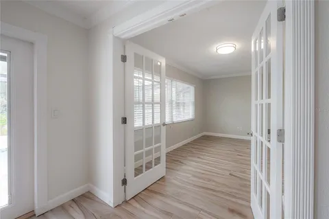 a view of a livingroom with wooden floor and a window