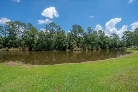 a front view of house with yard and trees
