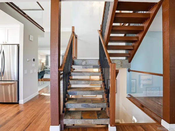a view of staircase with wooden floor and windows