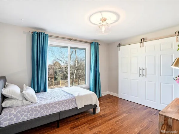 a bedroom with a bed and a large window