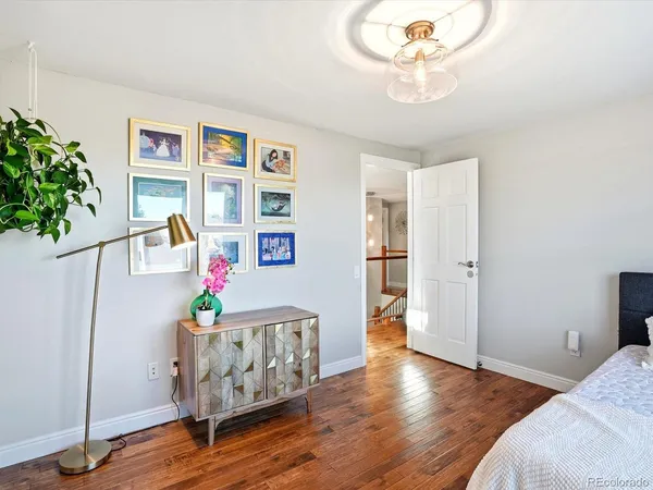 a bedroom with furniture and a potted plant