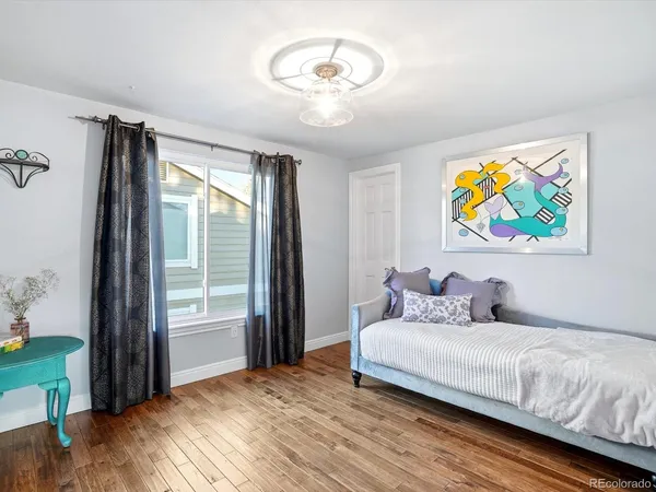 a bedroom with a bed and a painting on the wall