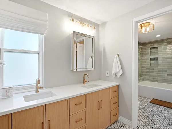 a bathroom with a double vanity sink and a mirror