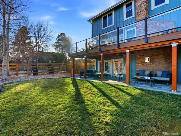 a view of a house with pool and chairs