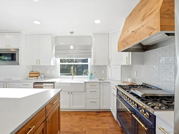 a kitchen with a stove a sink and a refrigerator