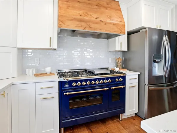 a kitchen with stainless steel appliances a stove a refrigerator and cabinets