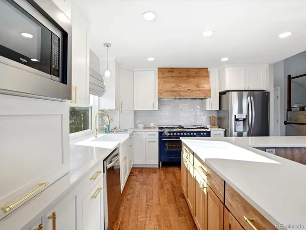 a kitchen with a sink a stove a refrigerator and a refrigerator