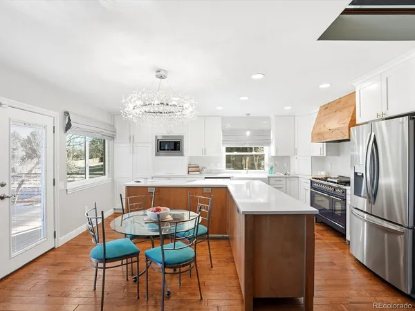 a large kitchen with a table and chairs