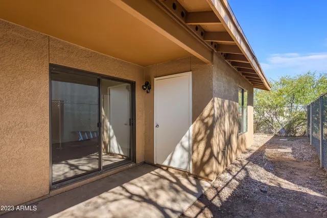 a view of an entryway with a floor to ceiling window and wooden floor