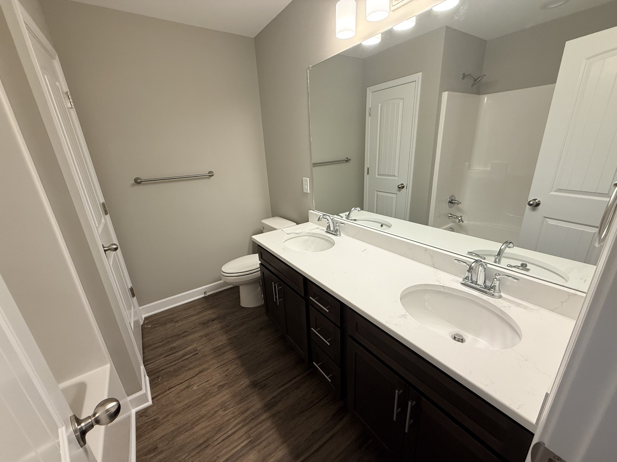 482 Ridge Street Manchester, TN 37355 - Photo 11 of 21 a bathroom with a double vanity sink and a mirror