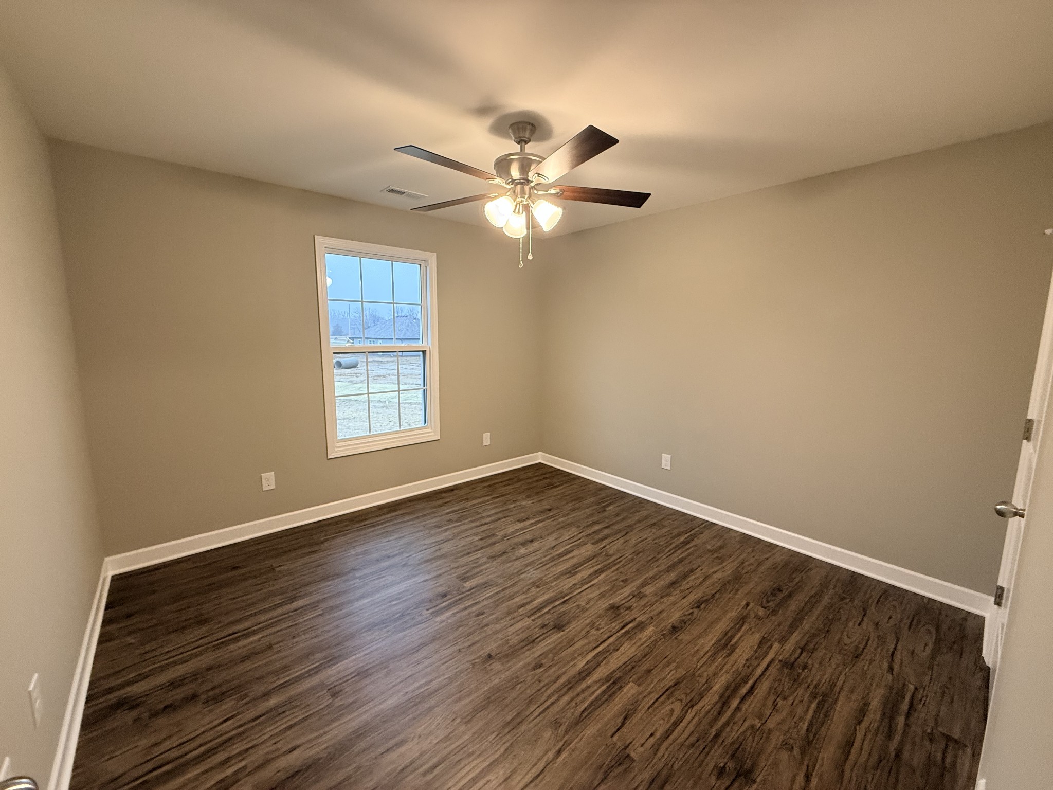 482 Ridge Street Manchester, TN 37355 - Photo 13 of 21 a view of an empty room with wooden floor and a window