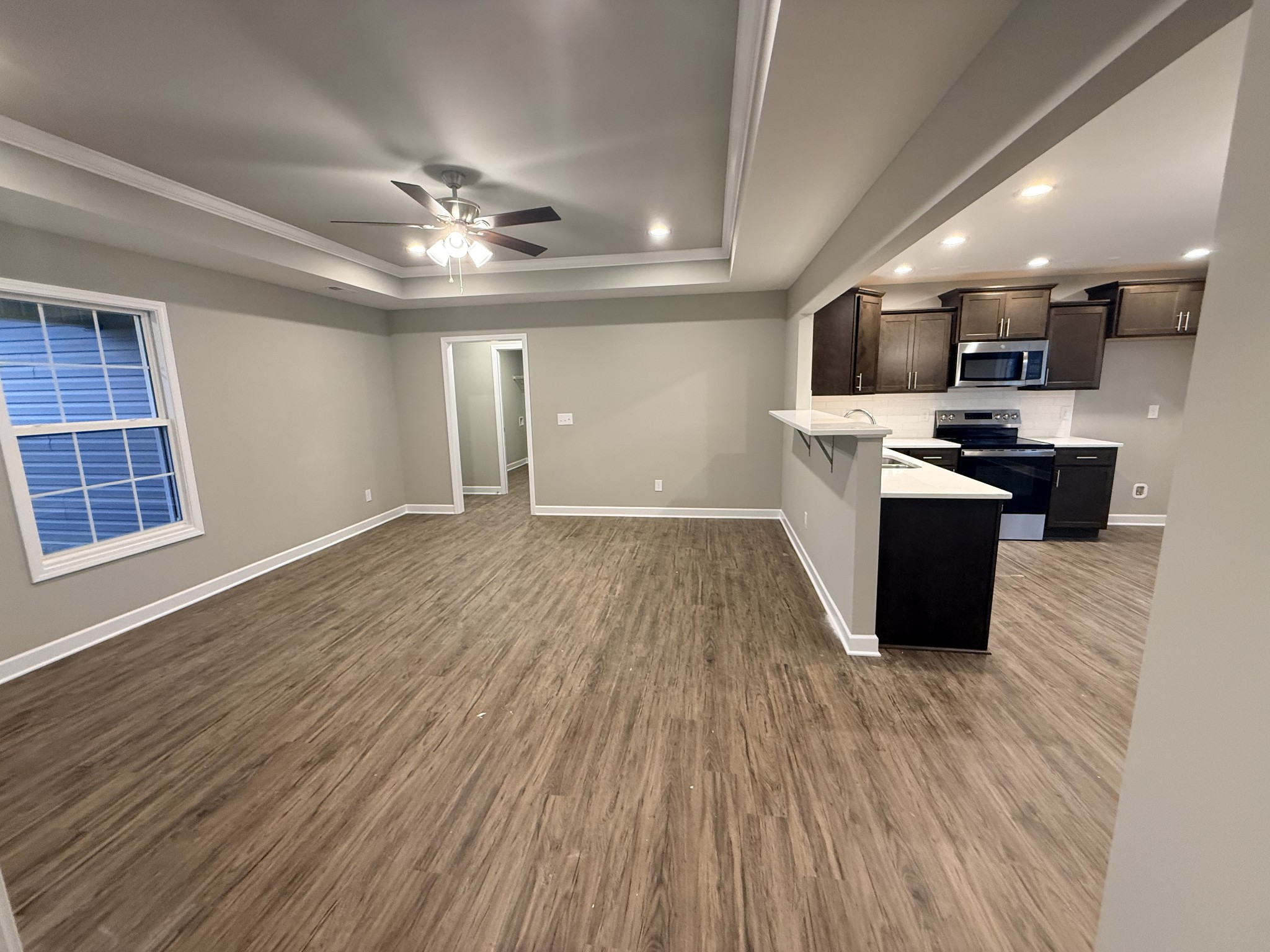 482 Ridge Street Manchester, TN 37355 - Photo 6 of 21 a large kitchen with stainless steel appliances granite countertop a large counter top and wooden floors