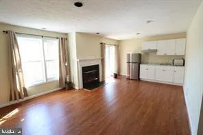 a view of a kitchen with a sink dishwasher and a fireplace