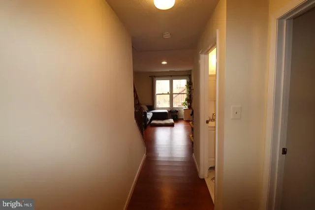 a view of a hallway with a livingroom with furniture