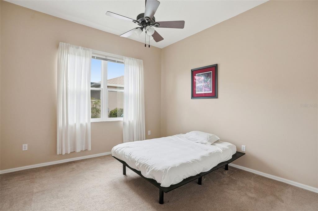 14228 Presteign Lane Spring Hill, FL 34609 - Photo 13 of 89 a bedroom with a bed and a window