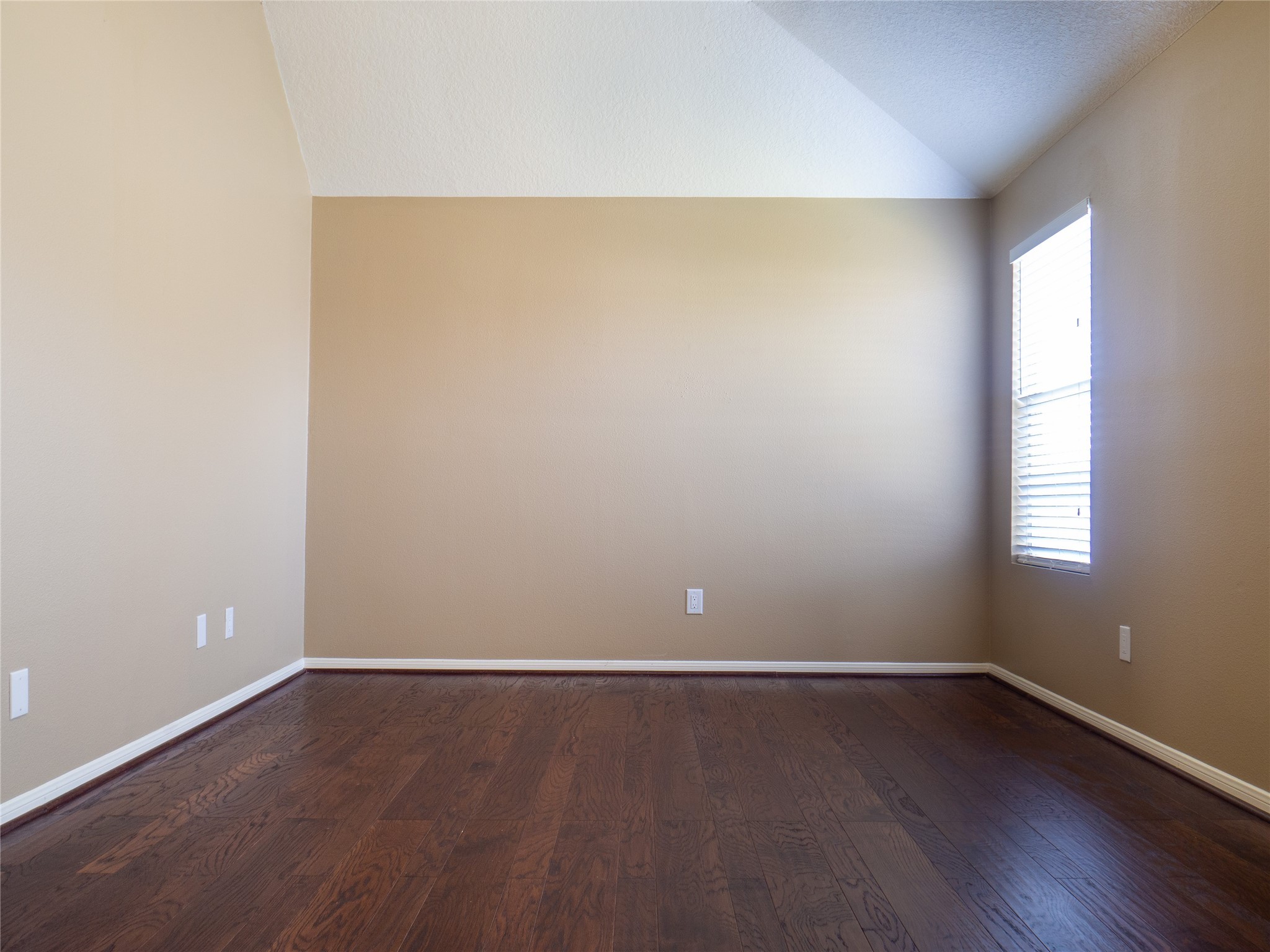 22527 Goss Spring Court Spring, TX 77373 - Photo 15 of 24 an empty room with wooden floor and windows with curtains