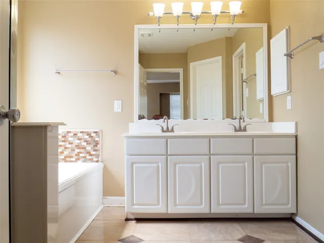 a bathroom with a sink vanity and a mirror