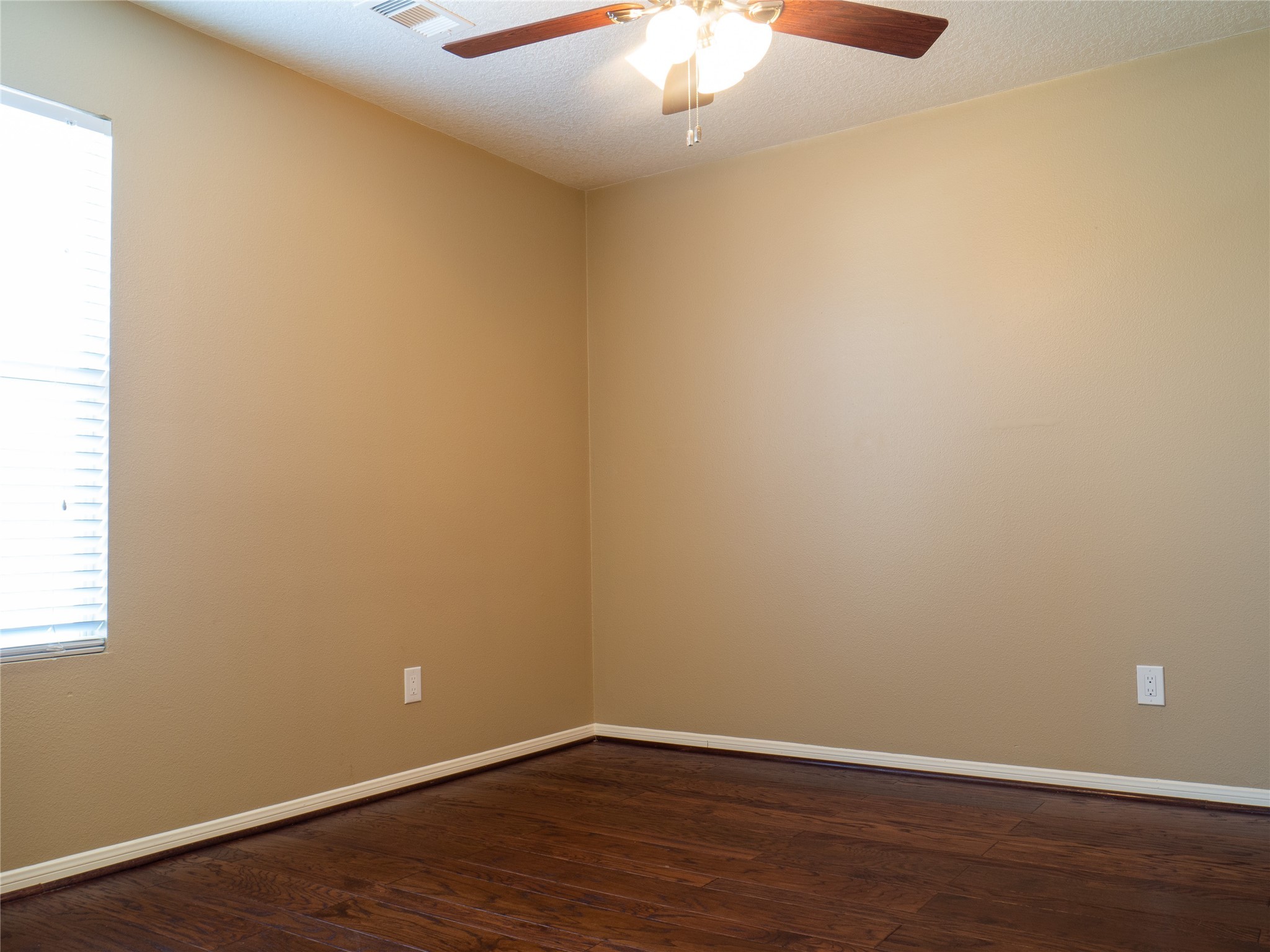 22527 Goss Spring Court Spring, TX 77373 - Photo 21 of 24 an empty room with wooden floor and chandelier fan