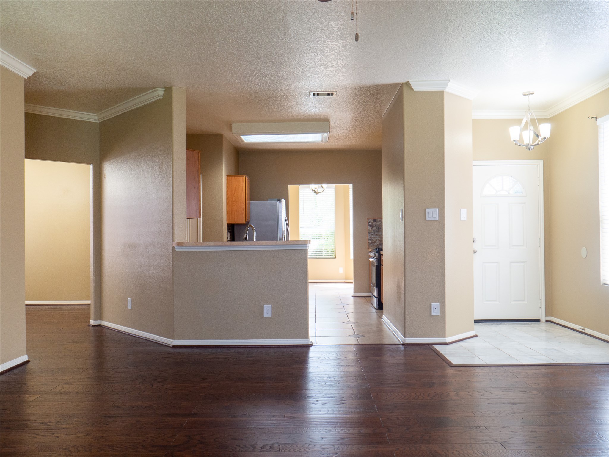 22527 Goss Spring Court Spring, TX 77373 - Photo 5 of 24 a view of a hallway with wooden floor and a living room