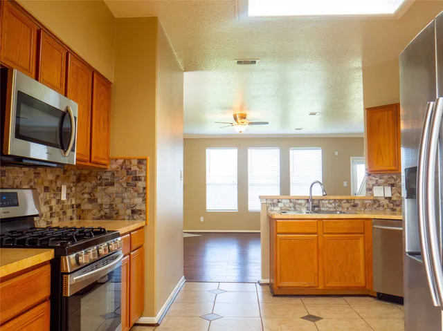 a kitchen with a stove a sink and a microwave