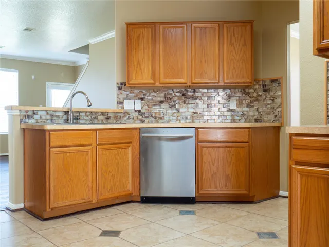 a view of kitchen with granite countertop cabinets and stove top oven