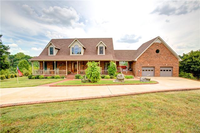 215 Carter Road Pulaski, TN 38478 - Photo 1 of 20 Front View of Home - What a welcoming entrance with the beautifully landscaped lawn and the covered front porch that runs the length of the home. The porch & sidewalk are brick pavers for easy maintenance.