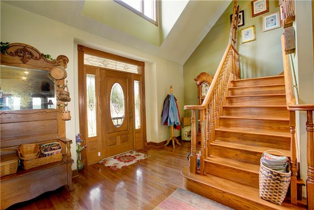 215 Carter Road Pulaski, TN 38478 - Photo 5 of 20 Foyer - The entryway to the home boasts a 2-story vaulted ceiling, hardwood flooring and a beautiful front door with side lights & transom.