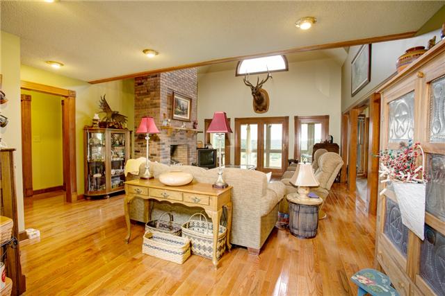215 Carter Road Pulaski, TN 38478 - Photo 20 of 20 Living Room - With 2-story vaulted ceiling, hardwood flooring, recessed lighting and a gas log fireplace. Very open floor plan from the foyer to the living room to the kitchen and breakfast area.