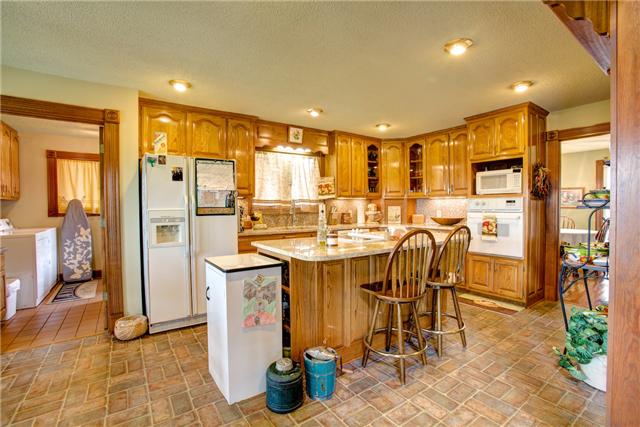 215 Carter Road Pulaski, TN 38478 - Photo 7 of 20 Kitchen - Features include granite counters, tile back splash, recessed lighting and island/eat-at bar. This space opens to the laundry room to the left and the dining room to the right.