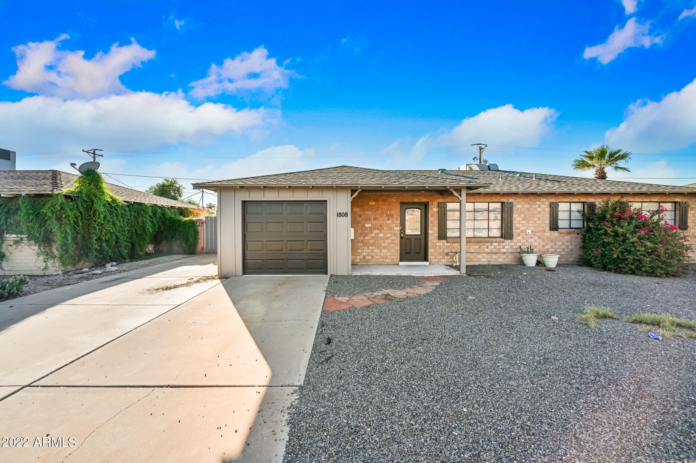 a view of a house with a backyard and garden