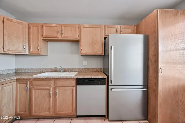 a kitchen with a refrigerator and cabinets